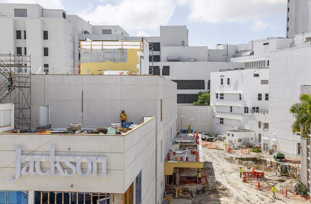 Construction crews work on the exterior of Jackson Memorial Hospital's new emergency department on Thursday, March 5, 2026, in Miami, Fla. The new facility doubles the size of their current emergency room and is expected to reduce patient wait times.