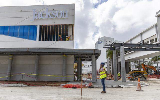 Construction crews work on the exterior of Jackson Memorial Hospital's new emergency department on Thursday, March 5, 2026, in Miami, Fla. The new facility doubles the size of their current emergency room and is expected to reduce patient wait times.