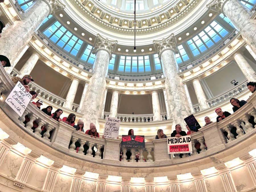 Hundreds of Idahoans gathered in the rotunda of the Idaho Capitol on Jan. 12, 2026, to protest budget cuts to the state’s Medicaid program. The protest, organized by Idaho Voices for Children, took place before the governor’s State of the State Address.