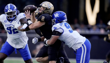 Vanderbilt quarterback Diego Pavia (2) is brought down from behind by Kentucky defensive lineman Mi'Quise Humphrey-Grace (90) during the second quarter at FirstBank Stadium in Nashville, Tenn., Saturday, Nov. 22, 2025. (© Mark Zaleski / The Tennessean / USA TODAY NETWORK via Imagn Images)