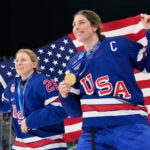 United States' Kendall Coyne, left, and United States' Hilary Knight celebrate after victory ceremony for women's ice hockey at the 2026 Winter Olympics, in Milan, Italy, Thursday, Feb. 19, 2026.
