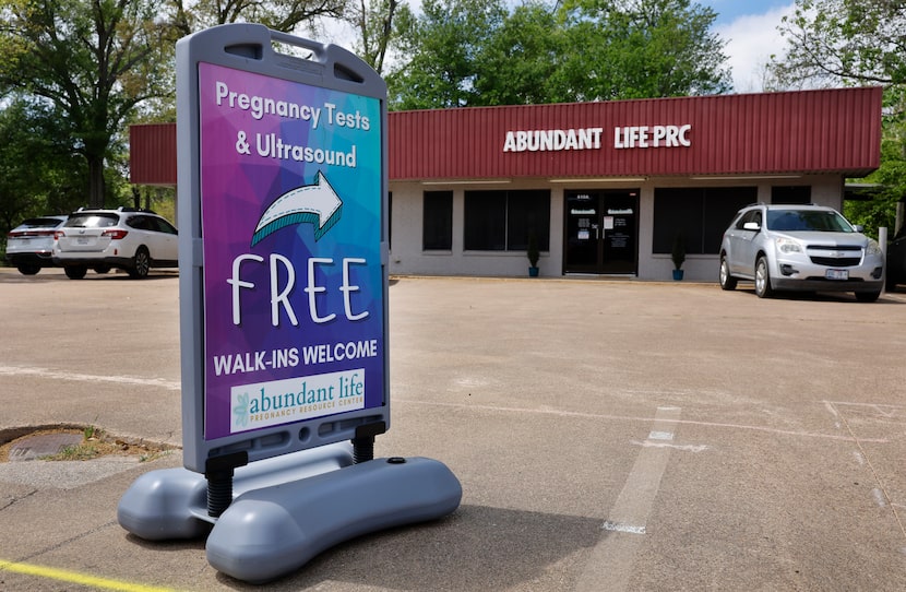 A sign for free walk-in pregnancy tests and ultrasounds draws attention to Abundant Life...