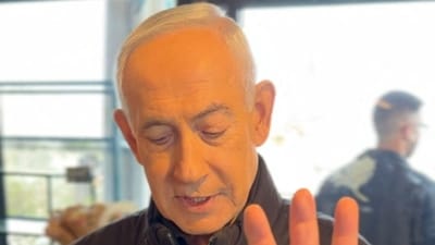 Israeli Prime Minister Benjamin Netanyahu shows his hand as he speaks at a cafe, amid the U.S.-Israeli conflict with Iran, in Jerusalem, March 15. (via REUTERS)