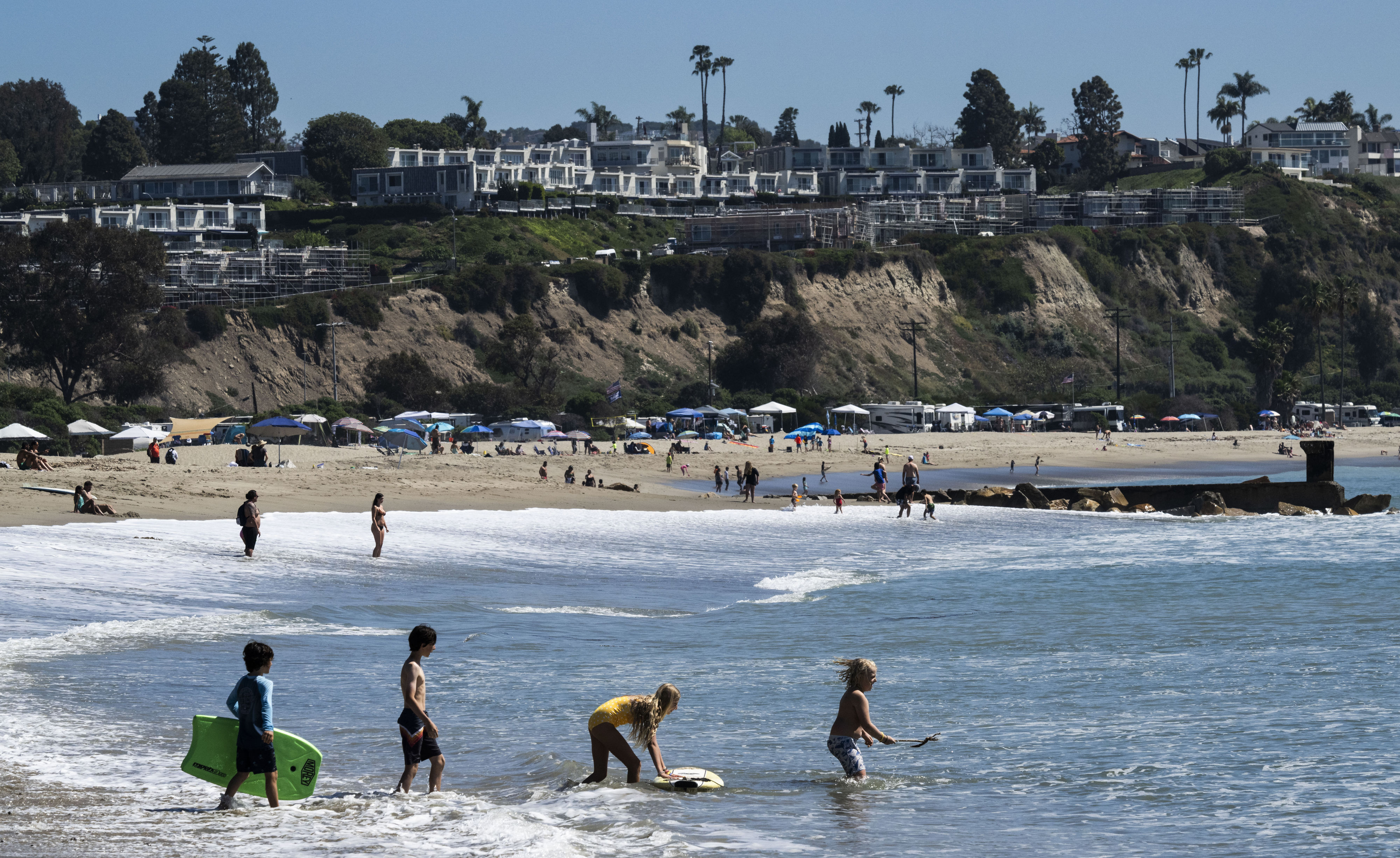 Kids play in the waves at Doheny State Beach in...