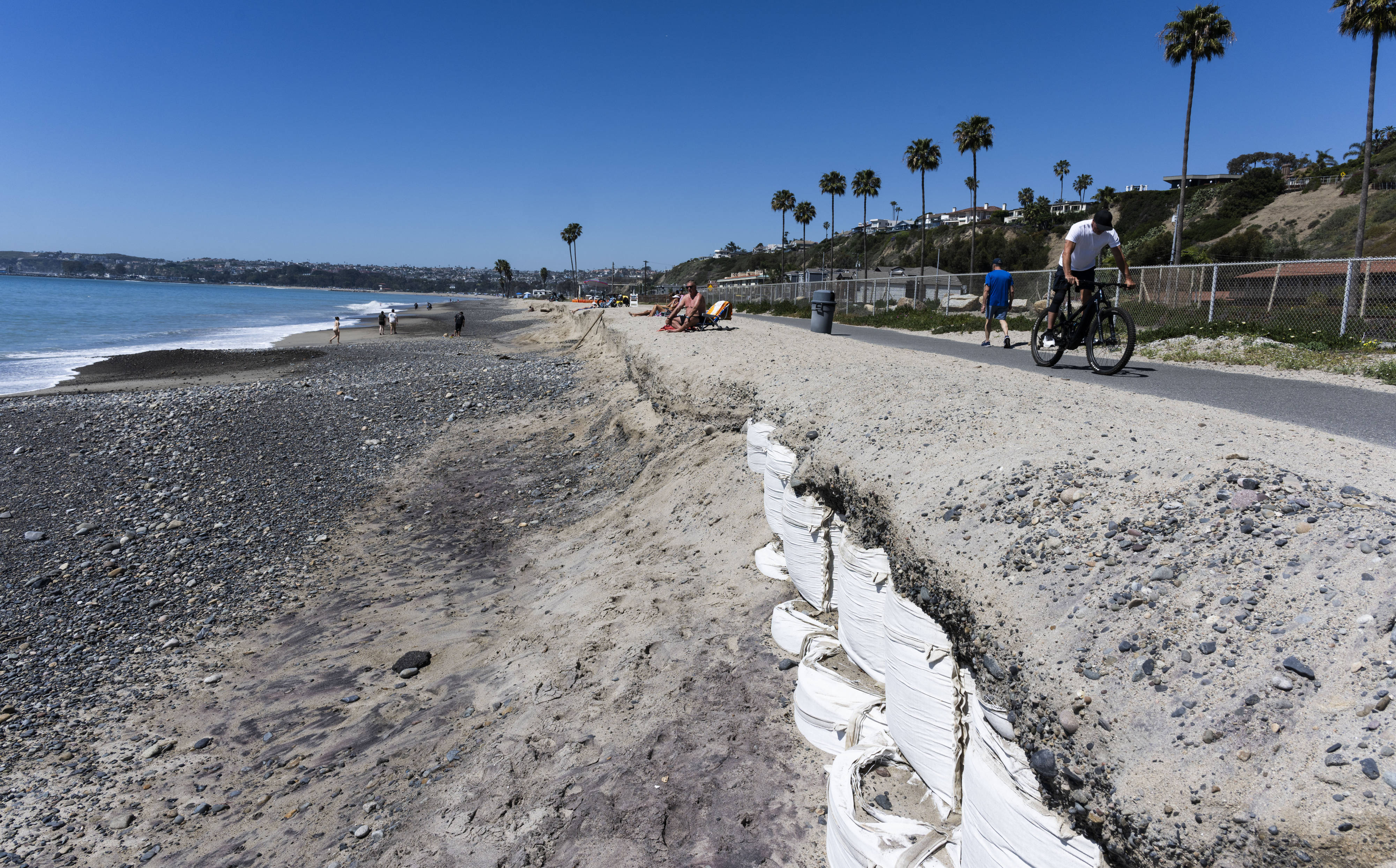 Sandbags help shore up the bike path at Capistrano Beach...