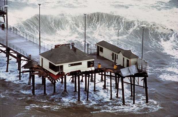 Huntington Beach Pier and its End Cafe are destroyed by El Nino's huge waves in 1983. Warm water could bring exotic sea life, but also kill kelp, and more frequent storms could spell trouble for the region. (Photo by H. Lorren Au Jr., Orange County Register/SCNG)