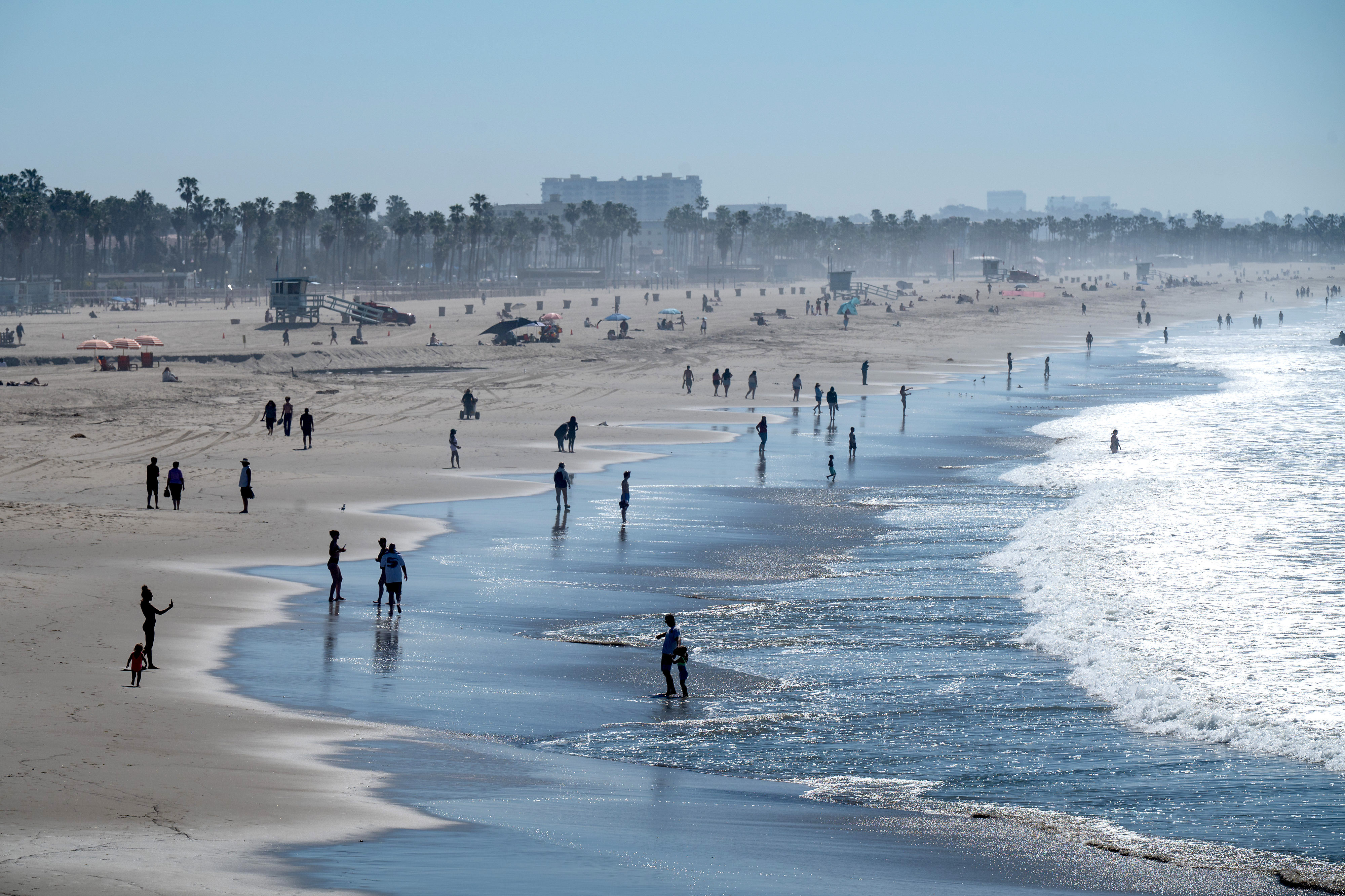 Visitors cool off in the ocean near the Santa Monica...