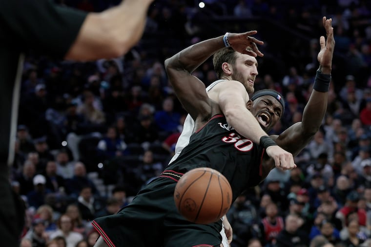 Sixers # 30 Adem Bona falls to the floor after being fouled by Spurs # 7 Luke Kornet in the first half of the San Antonio Spurs vs. Philadelphia 76ers (Sixers) NBA game at Xfinity Mobile Arena in Philadelphia on Tuesday, March 3, 2026.