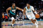 Charlotte Hornets forward Brandon Miller (24) drives against Portland Trail Blazers guard Scoot Henderson during the second half of an NBA basketball game in Charlotte, N.C., Saturday, Feb. 28, 2026.