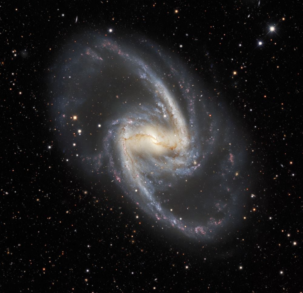 NGC 1365 is also known as the Great Barred Spiral Example. It's a stunning example of its galaxy type. It's about 56 million light-years away in the Fornax Cluster. Researchers have used chemical fingerprints based on oxygen to map out its history. Image Credit: By Dark Energy Survey/DOE/FNAL/DECam/CTIO/NOIRLab/NSF/AURAImage processing: Travis Rector (University of Alaska Anchorage/NSF’s NOIRLab), Jen Miller (Gemini Observatory/NSF’s NOIRLab), Mahdi Zamani &amp; Davide de Martin (NSF’s NOIRLab) - https://noirlab.edu/public/images/iotw2127a/, CC BY 4.0, https://commons.wikimedia.org/w/index.php?curid=107557546