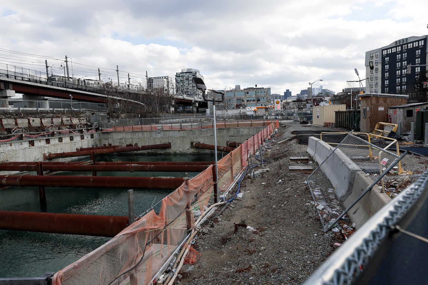 The spot where a Somerville lab project stalled and a waterlogged pit remains.