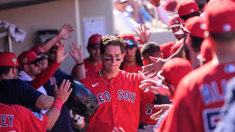 Boston Red Sox Roman Anthony is greeted in the dugout after scoring in the fourth inning of a spring training baseball game against the Minnesota Twins in Fort Myers, Fla., Wednesday, Feb. 25, 2026.