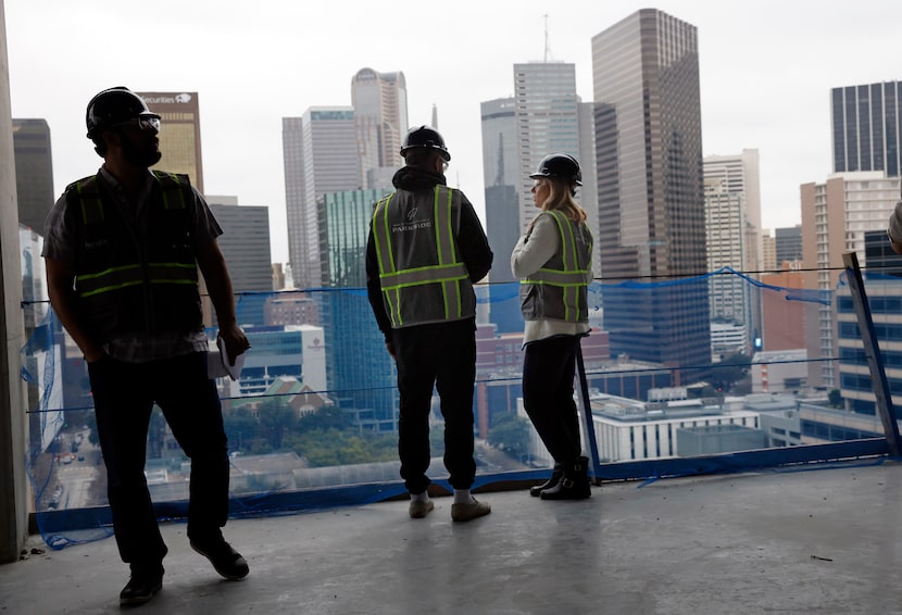 Reegan Busby (right), the Pacific Elm Properties vice president of leasing, stands on the...