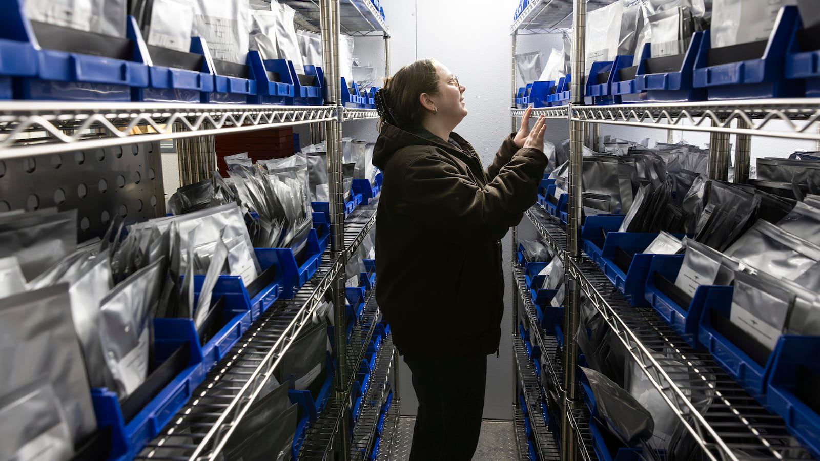 Scientist stands in cold storage seed bank at the Chicago Botanical Garden