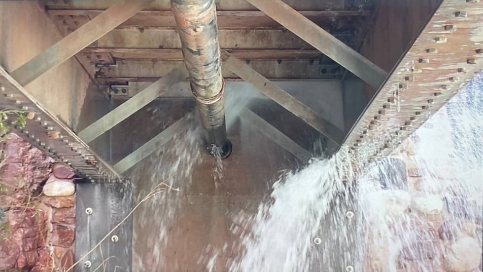 The pipeline break is leaking adjacent to a footbridge abutment along the North Kaibab Trail...
