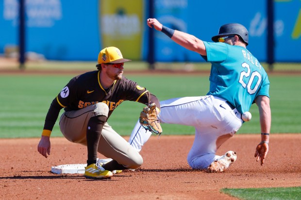 Jake Cronenworth #9 of the San Diego Padres tags out Luke Raley #20 of the Seattle Mariners during spring training game at the Peoria Sports Complex on Thursday, March 5, 2026 in Peoria, Ariz.(Meg McLaughlin / The San Diego Union-Tribune)