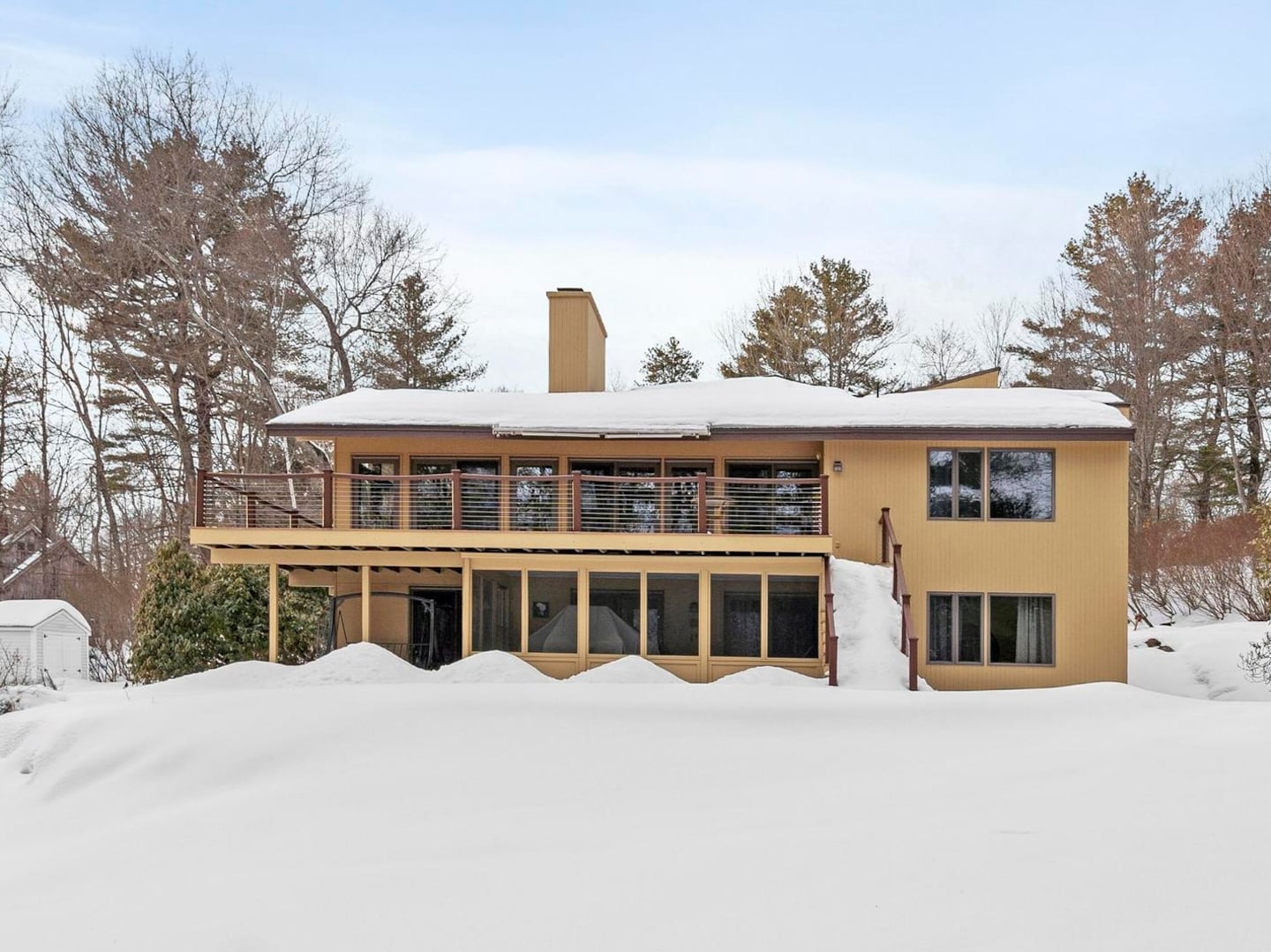The home has both a large deck and a screened-in porch to take in the natural view.