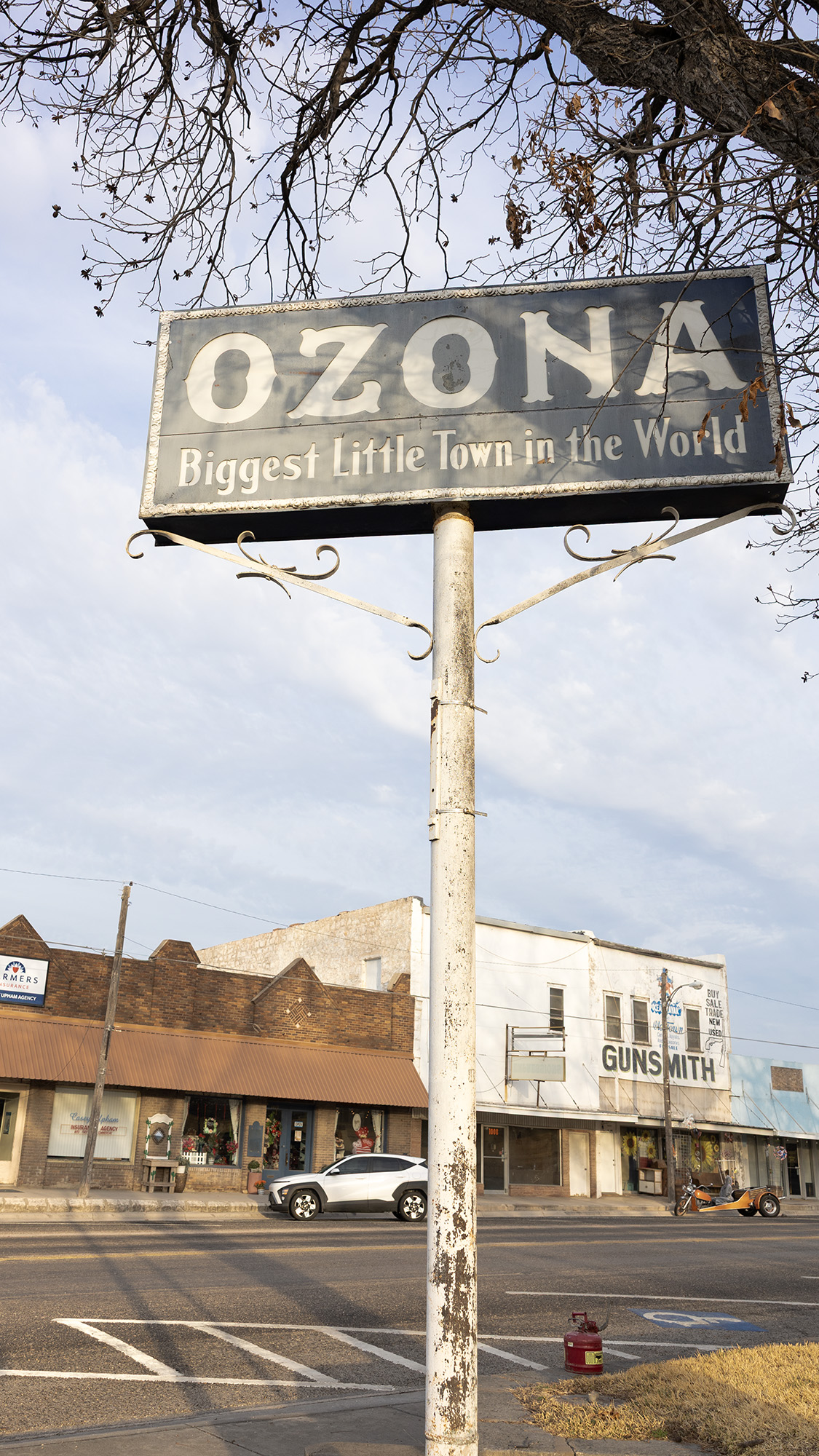 A tall street sign reads OZONA, Biggest Little Town in the World