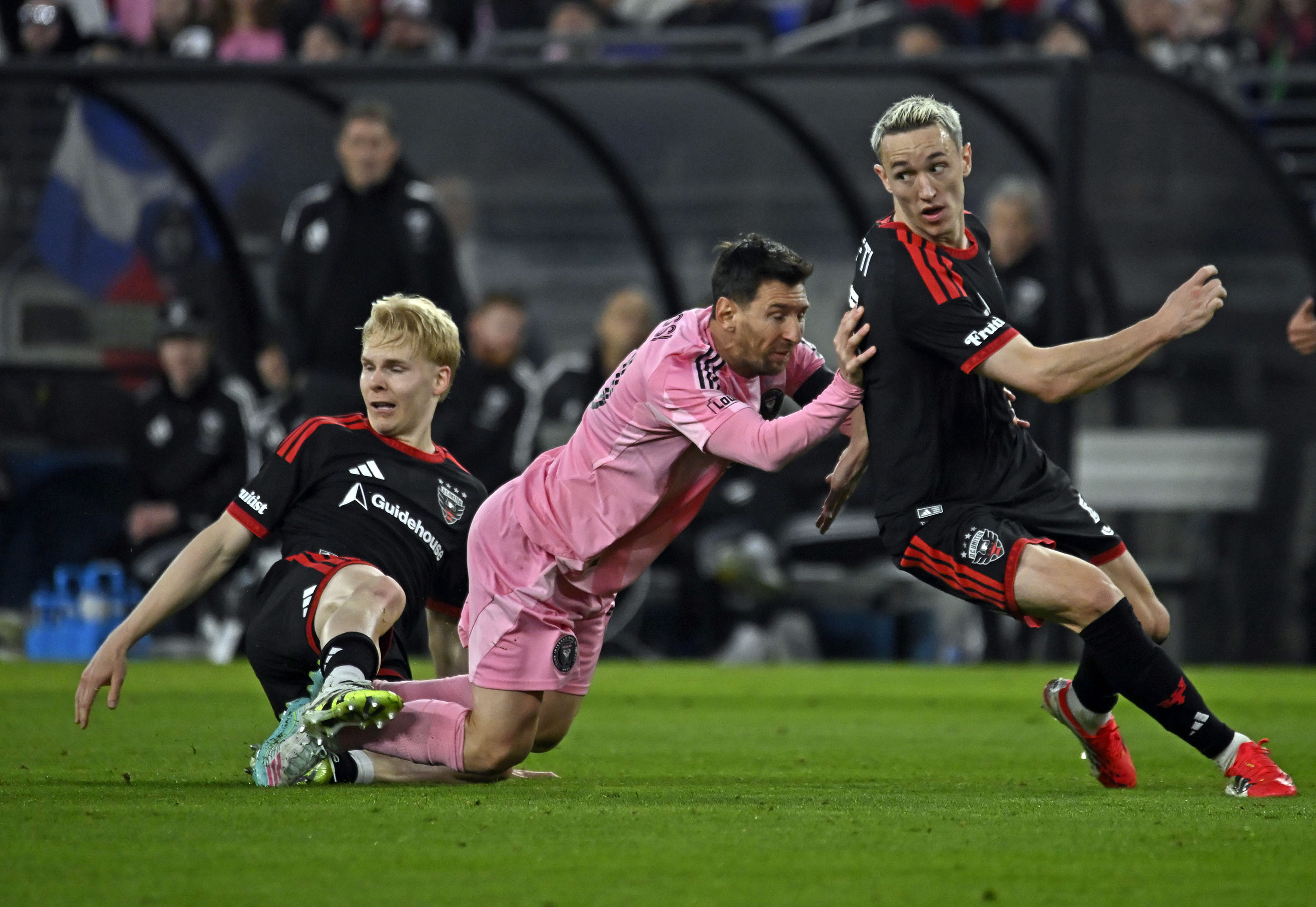 Inter Miami superstar Lionel Messi, center, is double teamed by...
