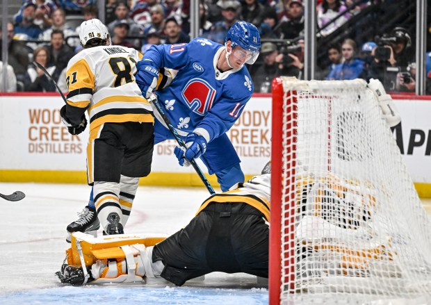 Brock Nelson (11) of the Colorado Avalanche gets stuffed by Arturs Silovs (37) of the Pittsburgh Penguins as Ben Kindel (81) defends during the third period at Ball Arena in Denver on Monday, March 16, 2026. (Photo by AAron Ontiveroz/The Denver Post)