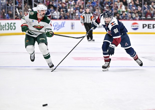 Nazem Kadri (91) of the Colorado Avalanche and Jake Middleton (5) of the Minnesota Wild race to the puck during the third period of the Avs' shootout win at Ball Arena in Denver on Sunday, March 8, 2026. (Photo by AAron Ontiveroz/The Denver Post)