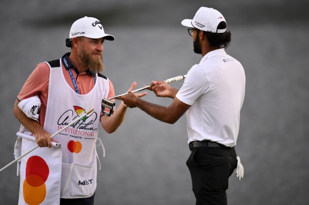 Akshay Bhatia of the United States celebrates with caddie Joe Greiner on the 18th green after winning the Arnold Palmer Invitational Sunday at Orlando's Bay Hill Club & Lodge. (Photo by Orlando Ramirez/Getty Images)