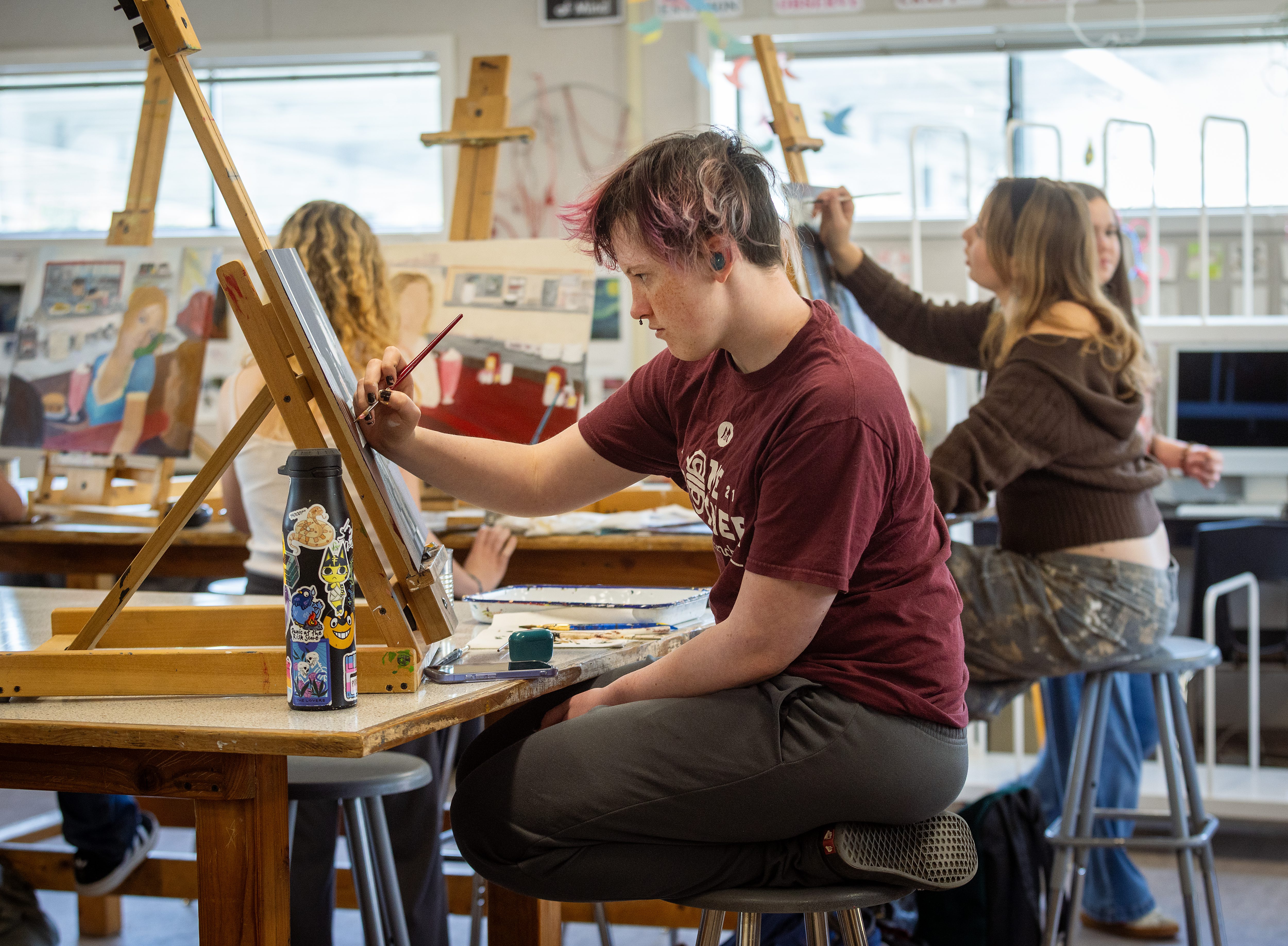 Junior Flynn Bryne focuses on completing a self-portrait project Tuesday,...