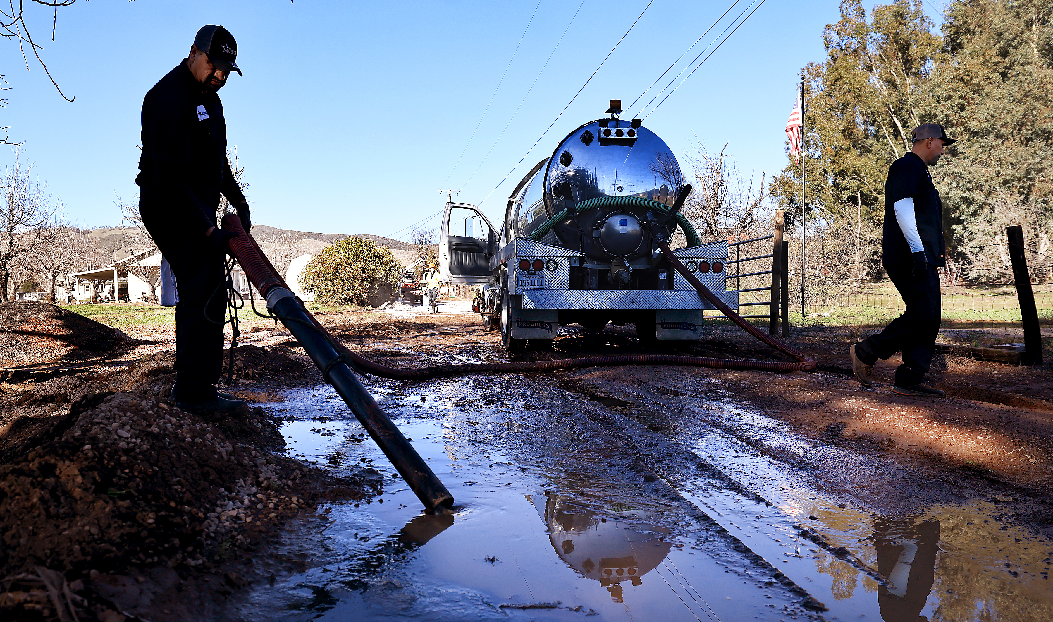 An Allstarz Pumping worker fro Sonoma County, vacuums up sewage...