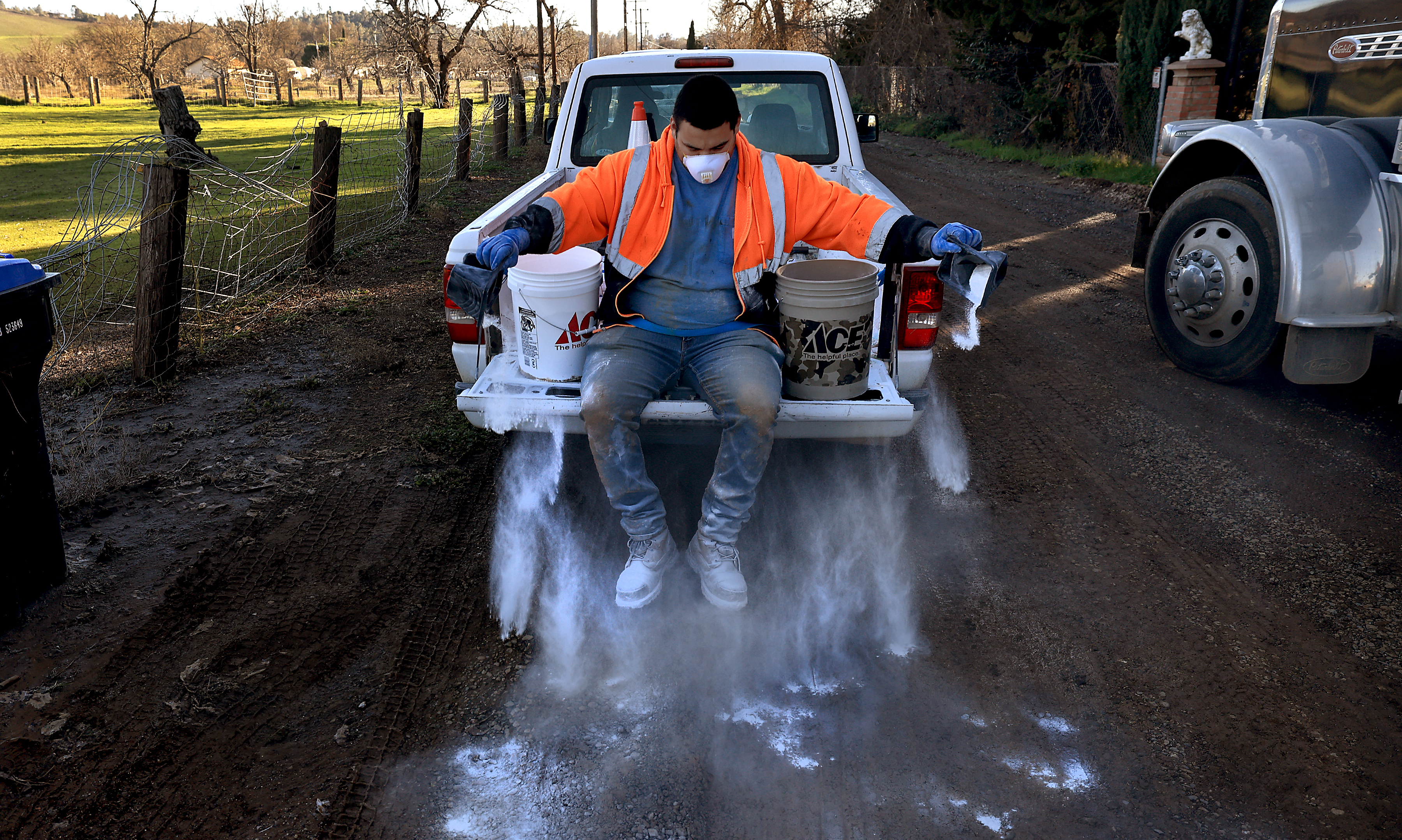 A County of Lake employee spreads agriculture lime on Robin...