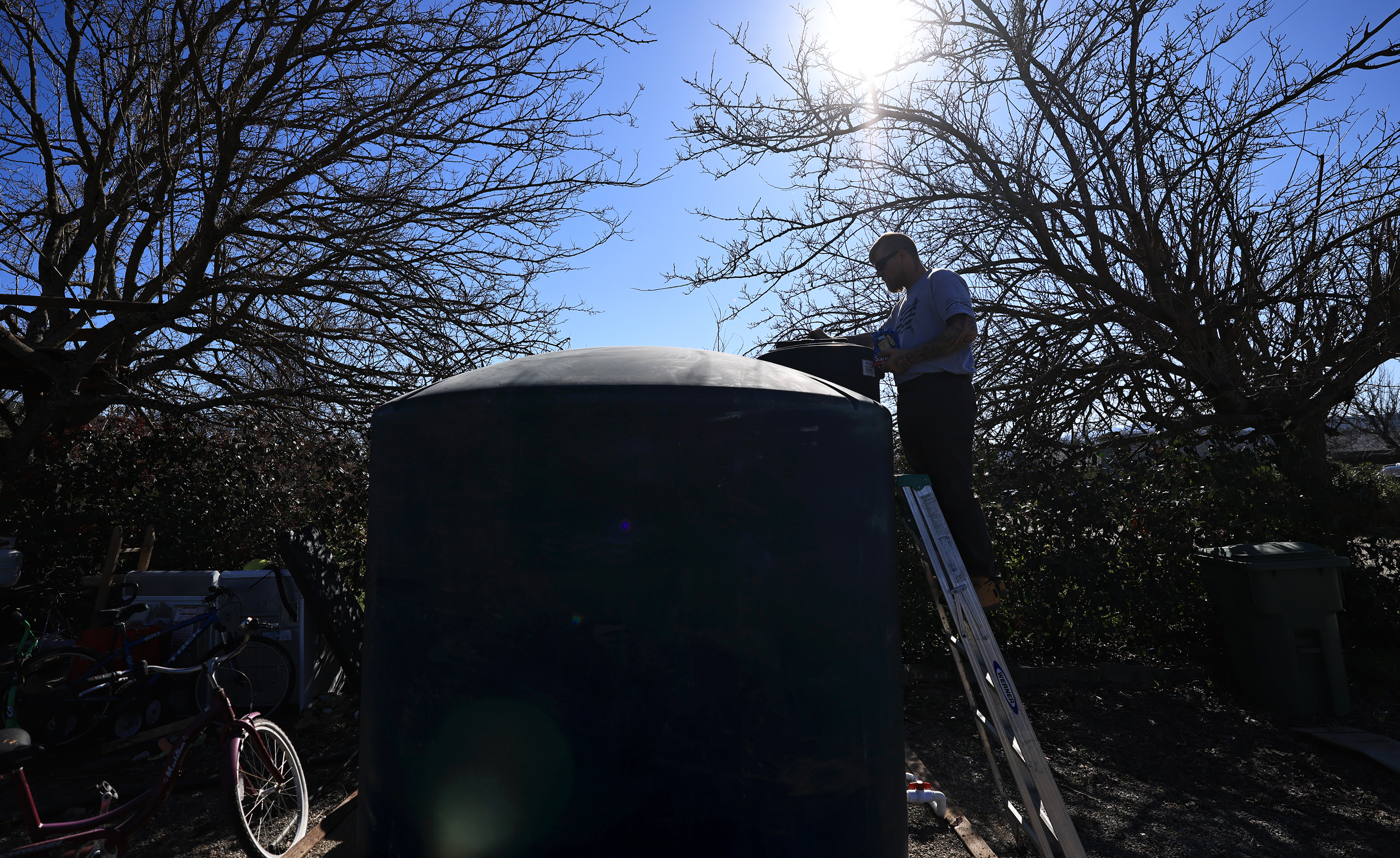 Joe Hulbert checks the water level in a county supplied...