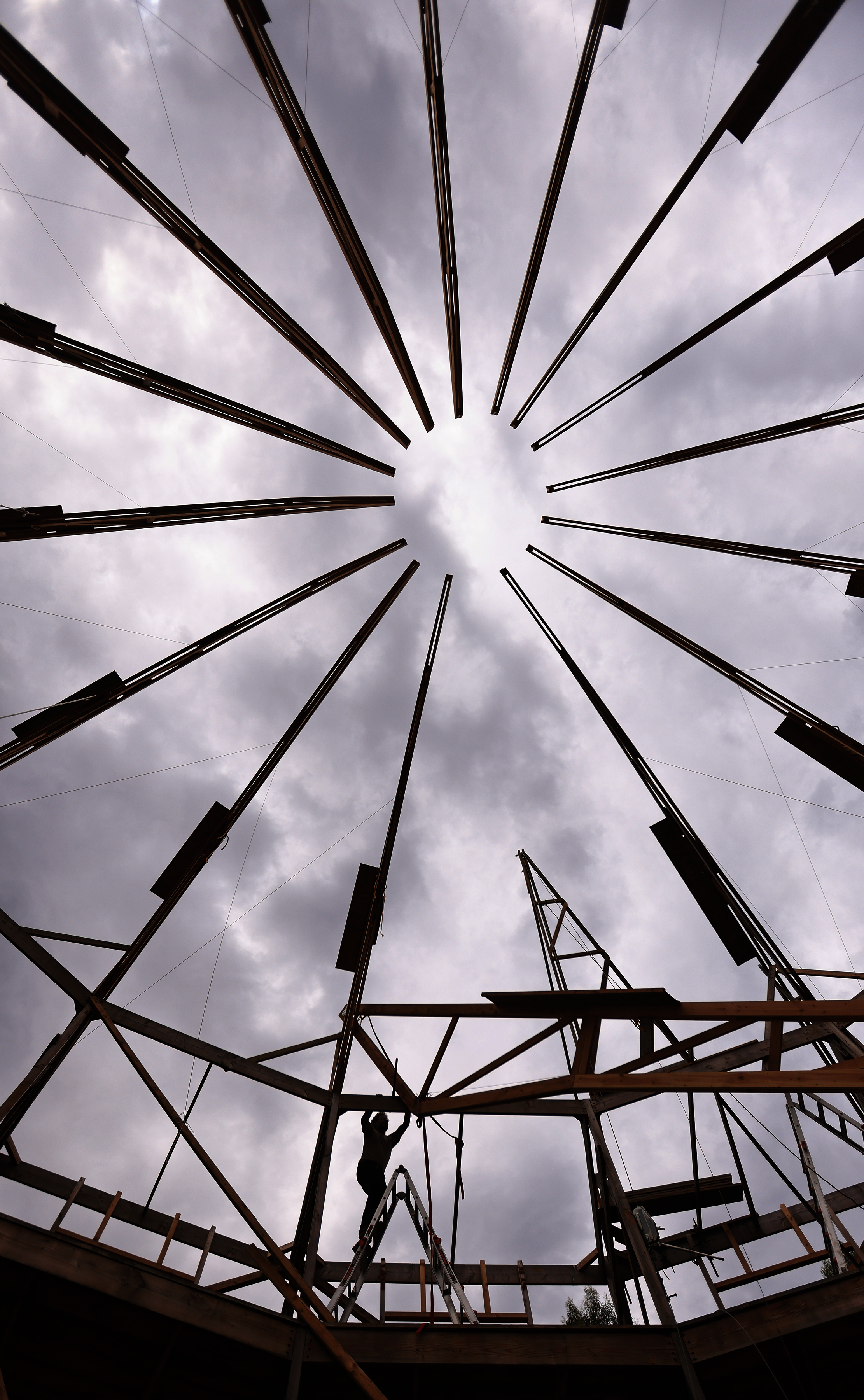 Ken Moholt-Siebert raises the last rafter on a life size...