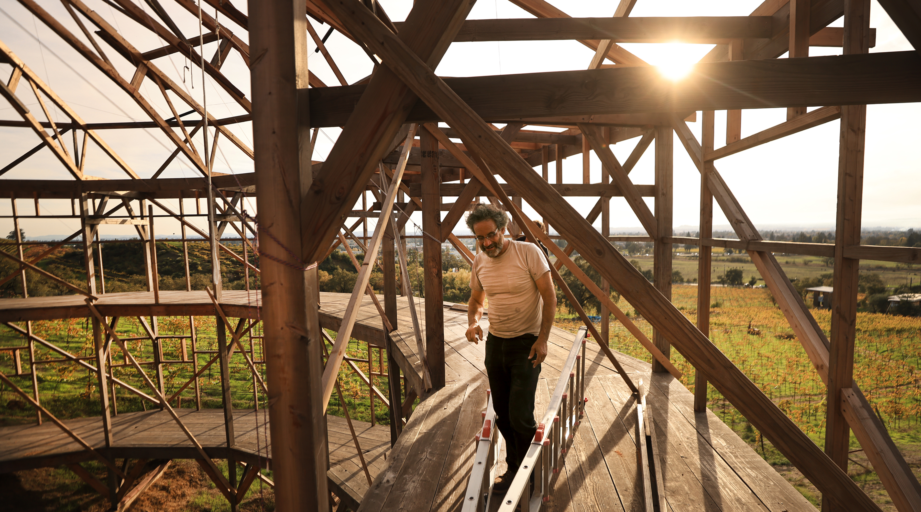 Ken Moholt-Siebert, adjusts wires used to secure rafters due to...