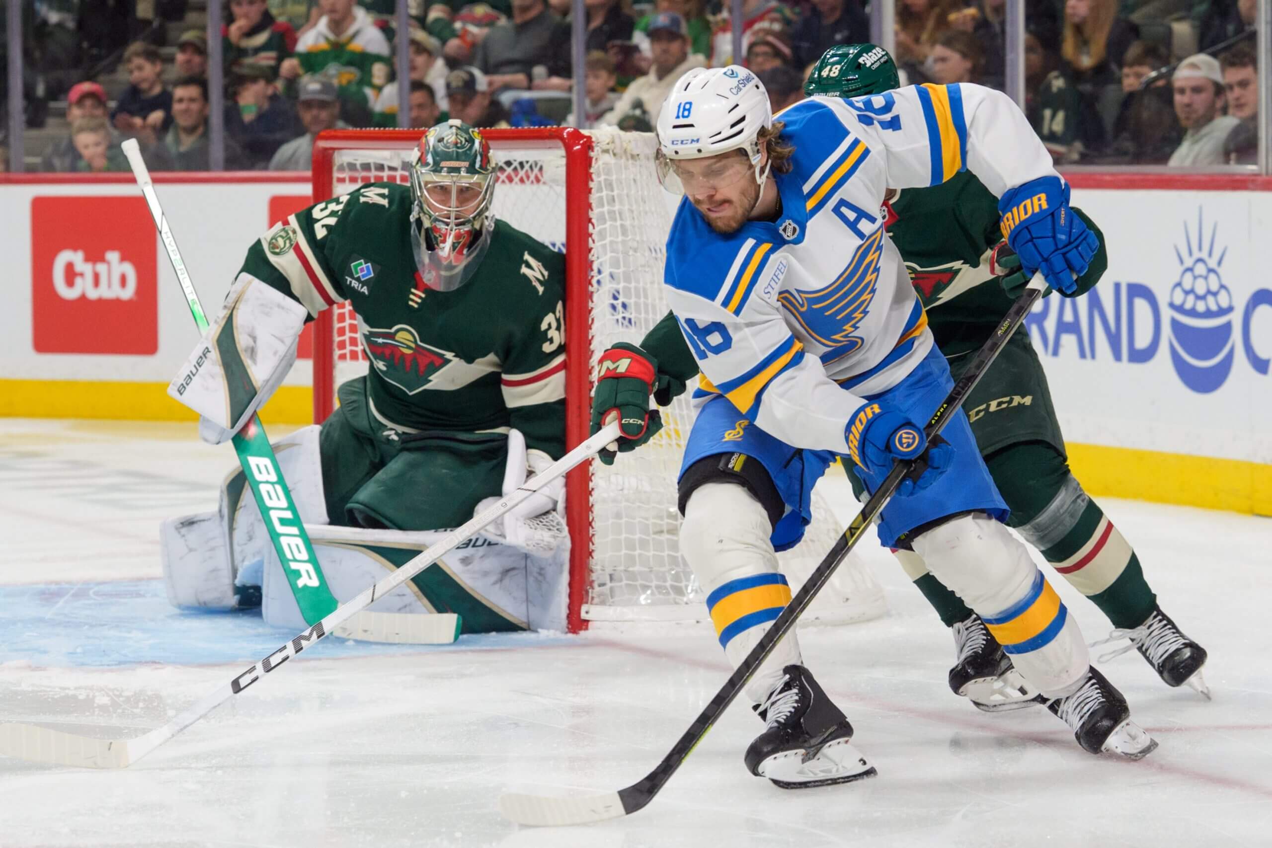 St. Louis Blues center Robert Thomas, right, attempts a wrap around on Minnesota Wild goaltender Filip Gustavsson, left.