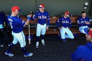 Texas Rangers third baseman Josh Jung (6) fist bumps manager Skip Schumaker in the dugout...
