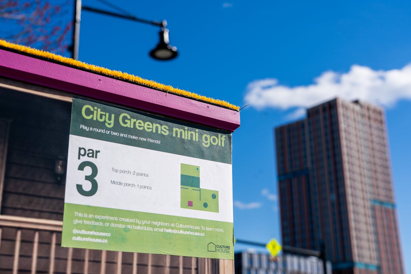 A placard on the side of the mini-golf hole indicates it's a "par 3."