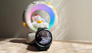 a galaxy watch 8 in front of a night light with a cat sleeping on a moon