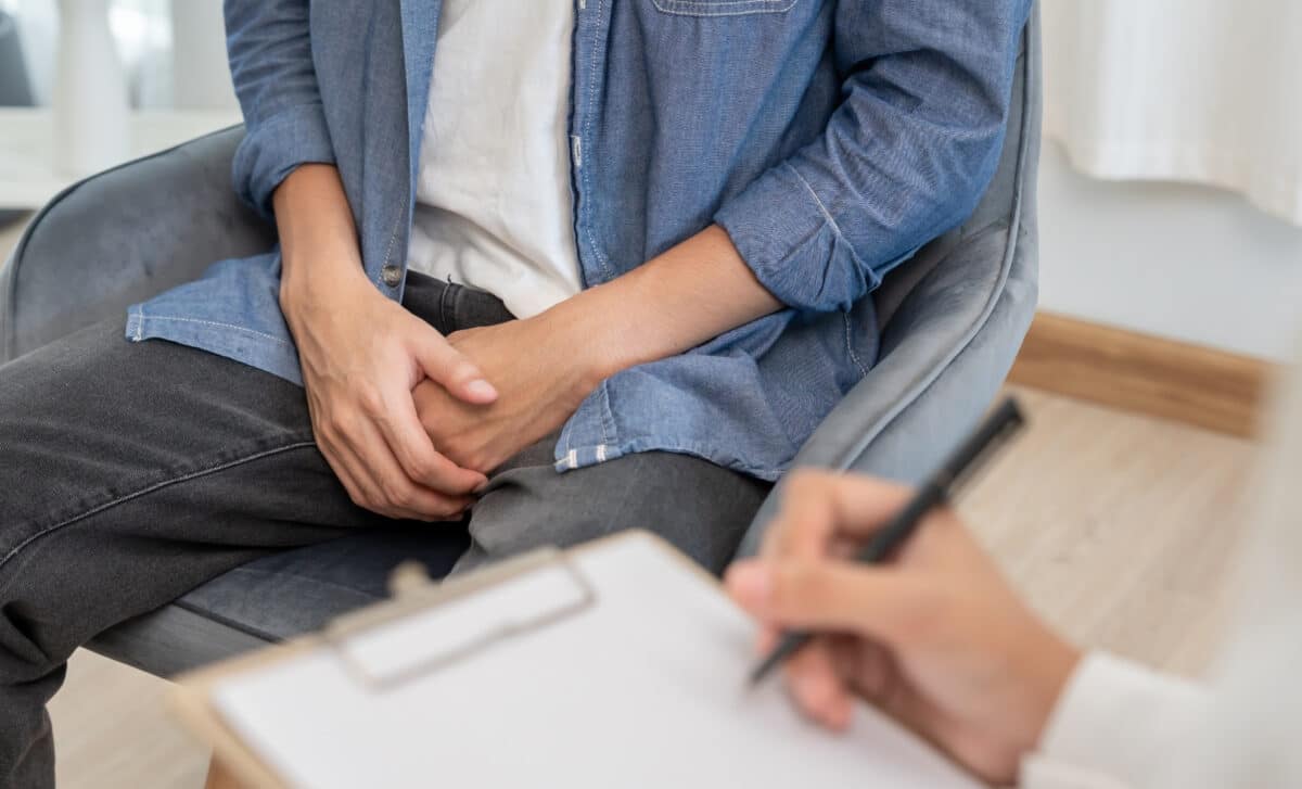 A Man Holding His Hand In Front Of His Genitals May Experience Discomfort And Should Consult A Doctor