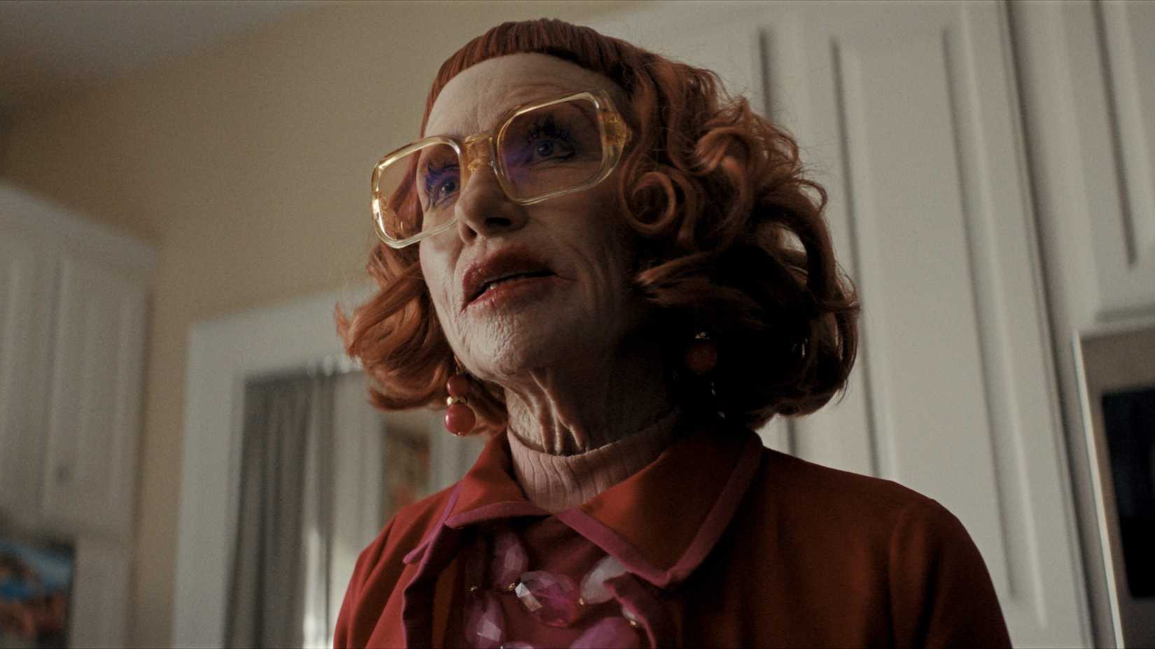 A mid-shot of Aunt Gladys in full makeup angled from below in Weapons