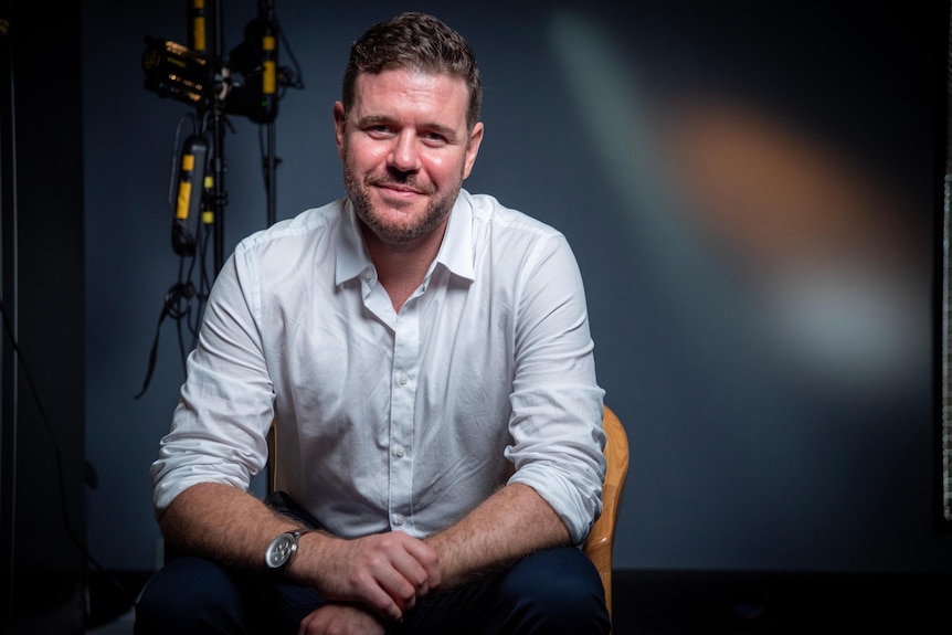A man sits in a chair. 