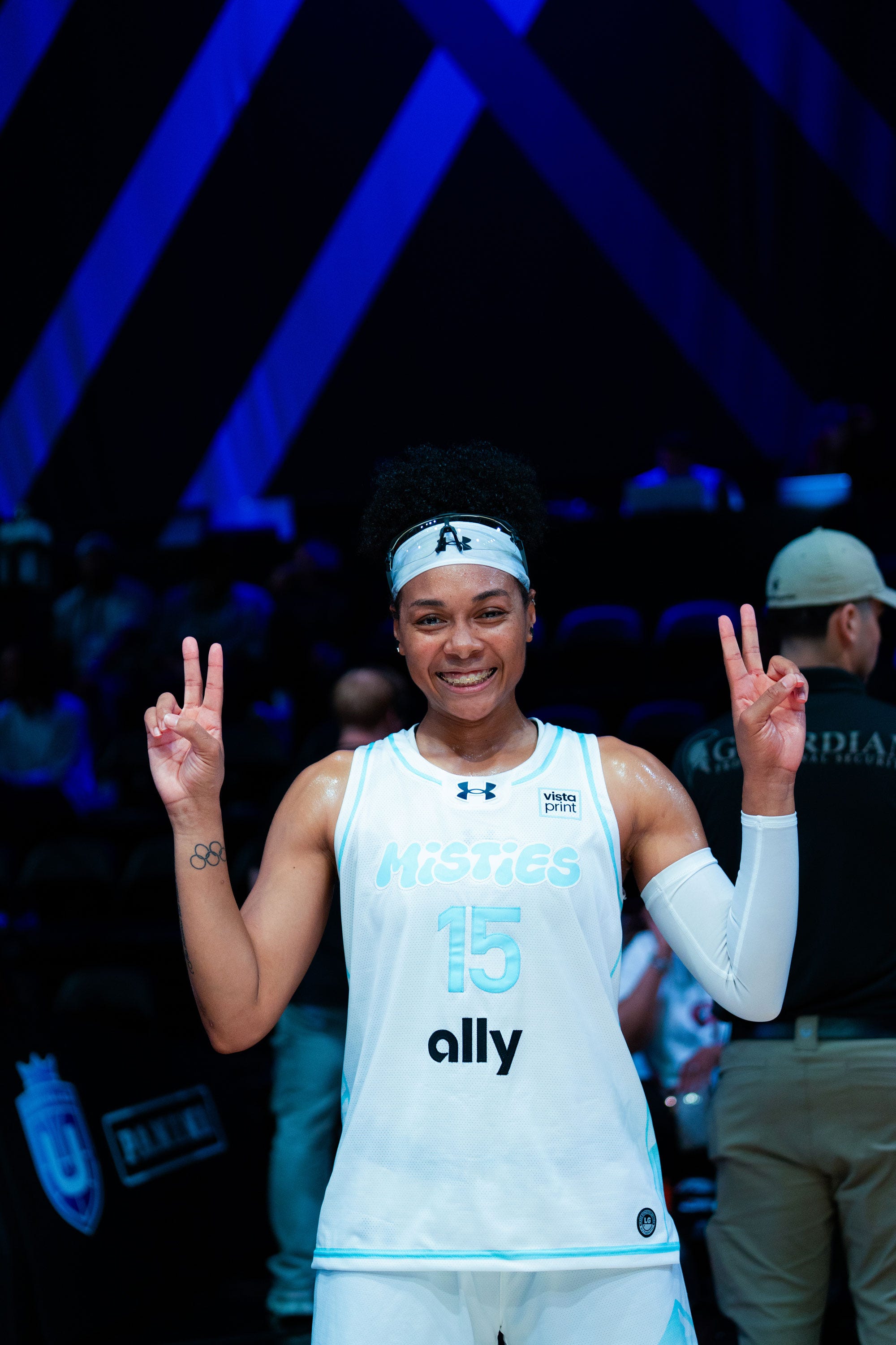 basketball player signaling victory with a peace sign