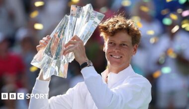 Jannik Sinner holds the trophy in celebration after winning the Indian Wells title