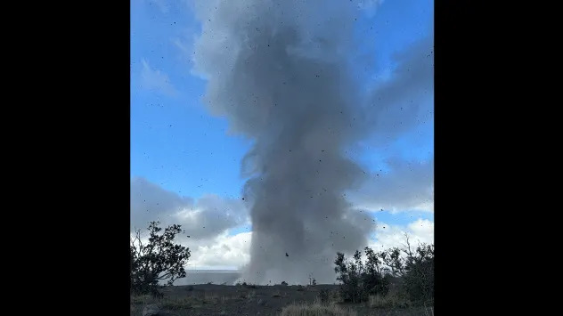 A photo showing volcanic rock and ash (tephra) raining down from a lava fountain and a gas plume at the summit of Kilauea in Hawaii during eruption 43. (Image: NPS)