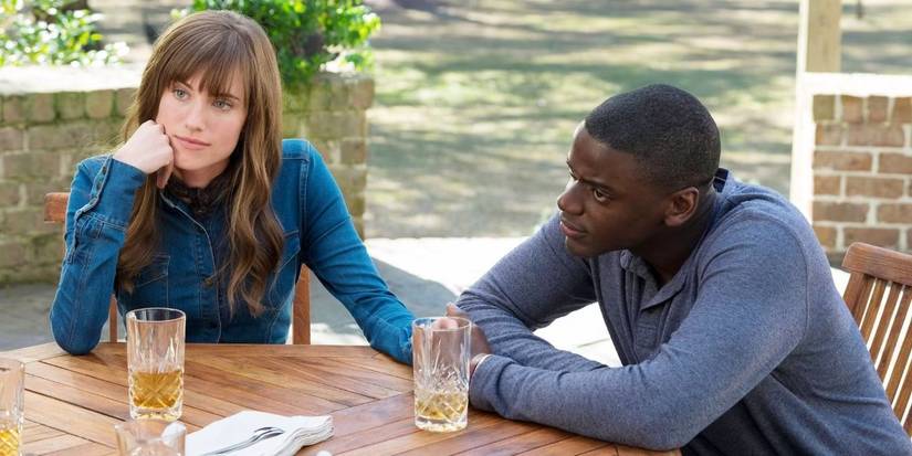 Rose and Chris smiling while looking in the same direction in Get Out 2017