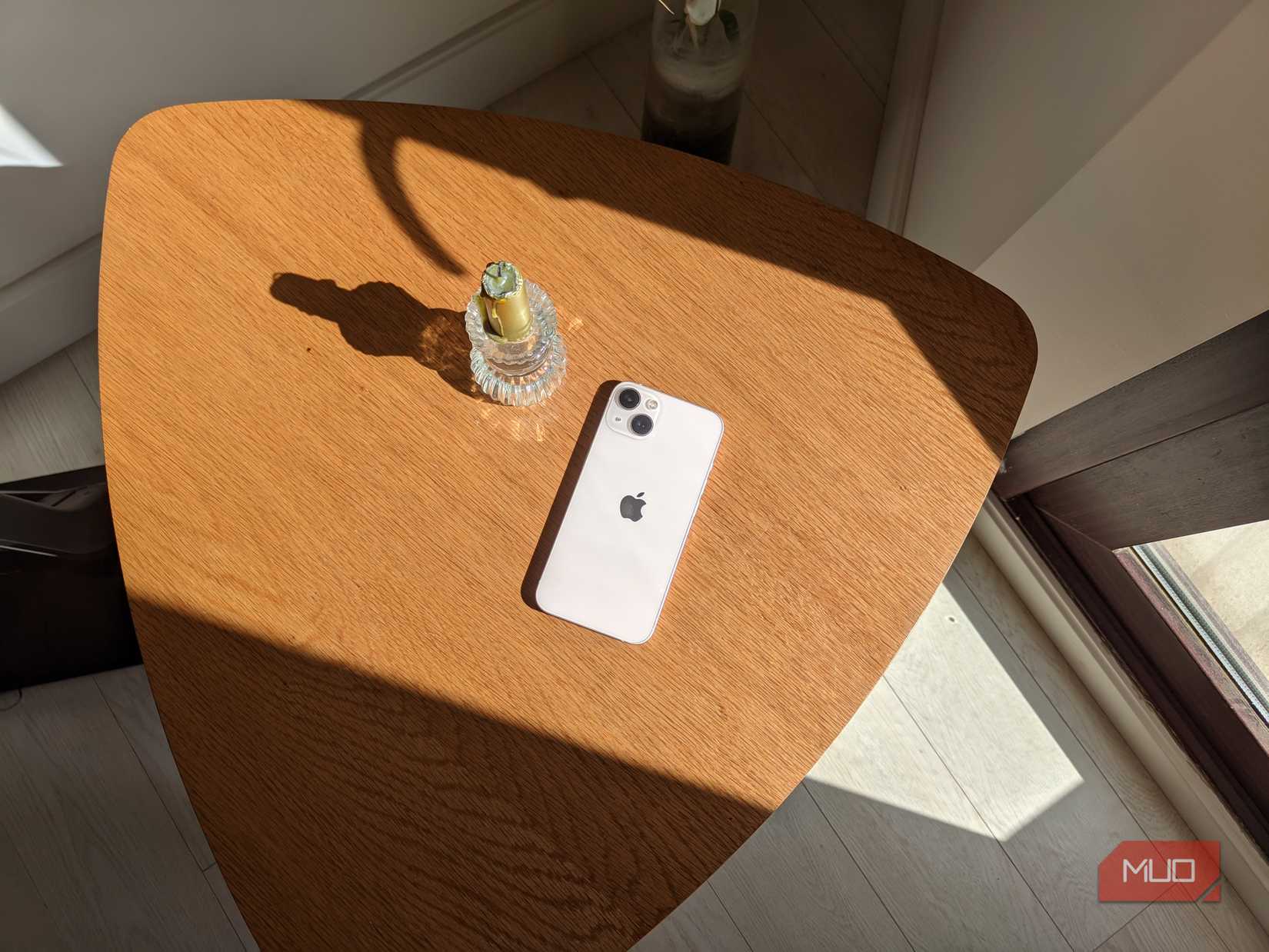 An iPhone next to a candle on a table shot on GCam Android