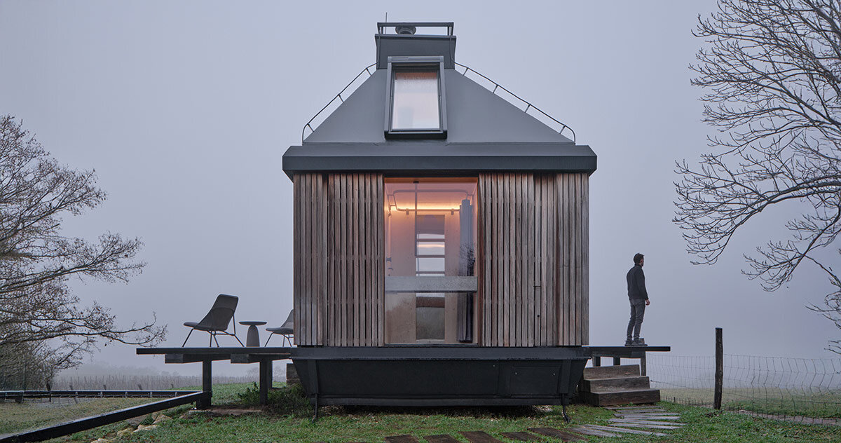 ark-shelter & archekta craft off-grid cabin with a fold-down facade in devín, slovakia