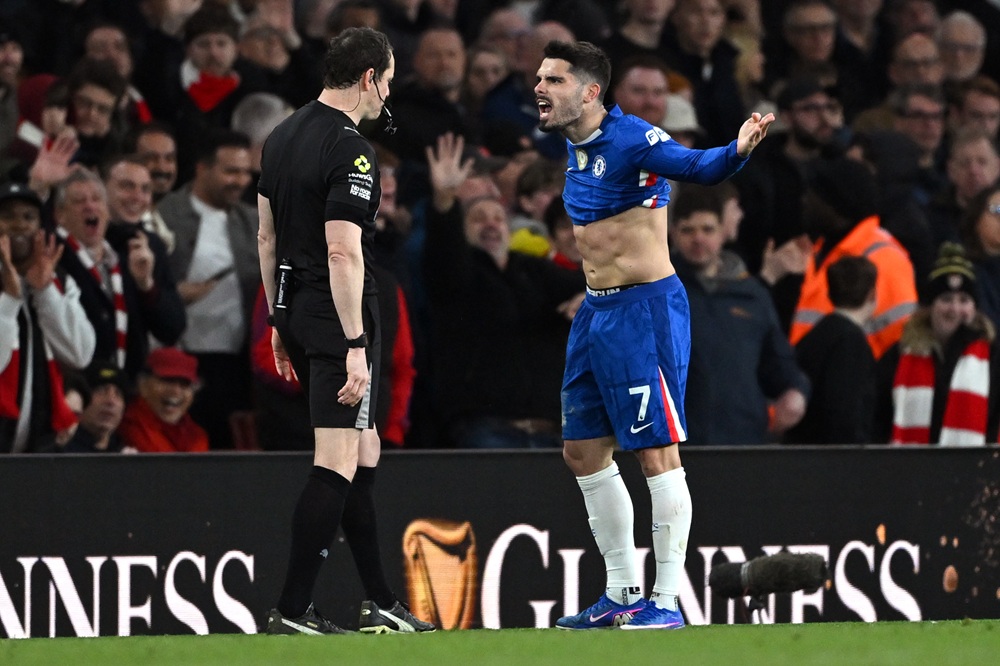 Pedro Neto of Chelsea reacts towards Referee Darren England after showing him a red card during the Premier League match between Arsenal and Chelse...