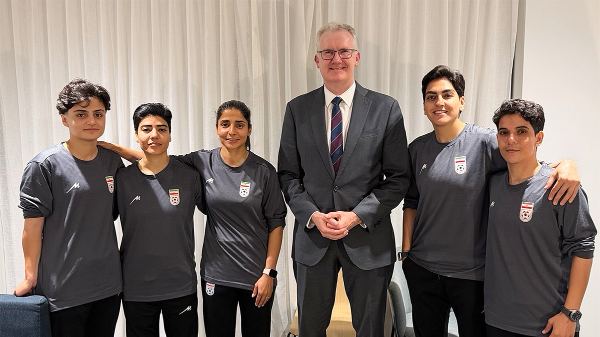 Australian Home Affairs Minister Tony Burke and five Iranian women soccer players