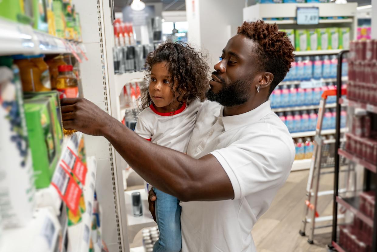 Little girl and her father in a supermarket.