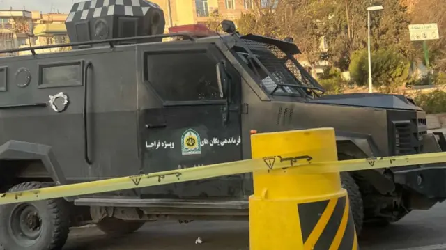 A vehicle belonging to Iran’s Police Special Forces sits by yellow caution tape