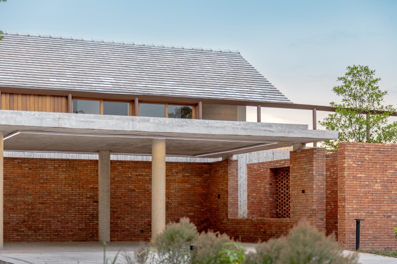 brick and concrete sculpt elevated riverfront residence in thailand by bodinchapa architects - 3